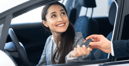 Mulher jovem prepara-se para conduzir um carro emprestado. Mulher jovem prepara-se para conduzir um carro emprestado.